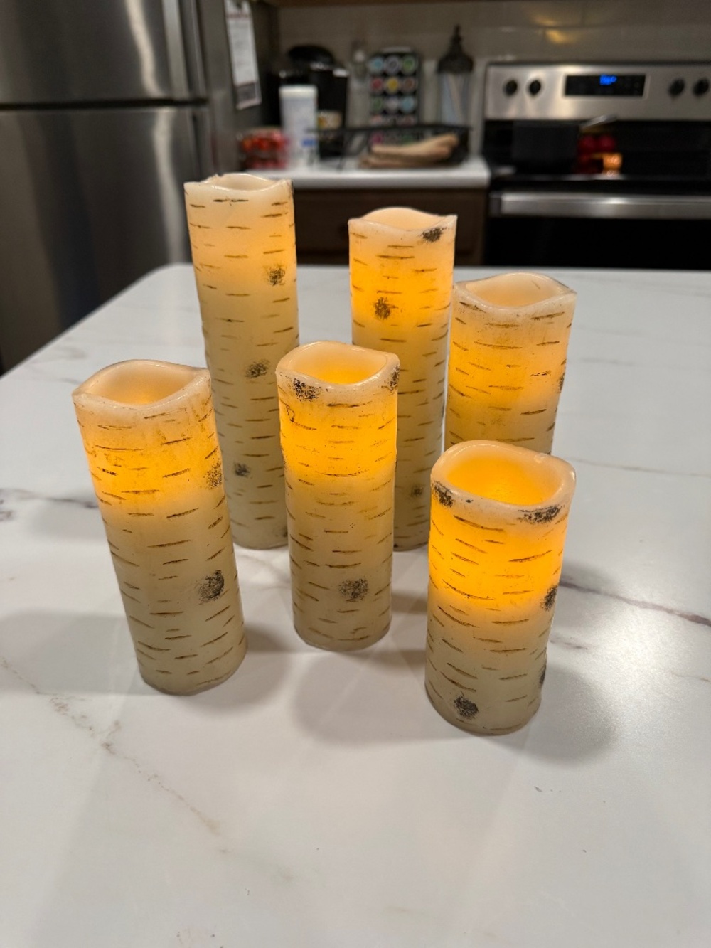 Flameless LED pillar candle designed to look like natural birch tree logs!